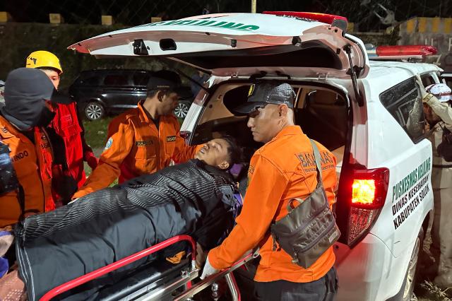 Rescuers transferring a survivor into an ambulance after a landslide in West Sumatra Indonesia Sept 28 2024 AFP- Yonhap