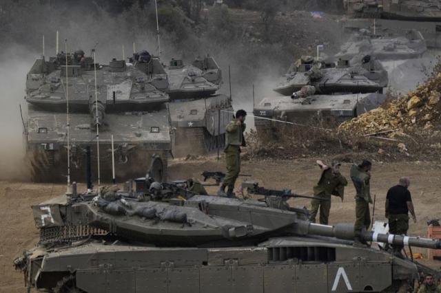 Israeli army tanks maneuver in a staging area in northern Israel near the Israel-Lebanon border on Oct 1 2024 AP-Yonhap