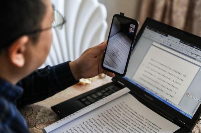 A judge is seen discussing cases with a colleague over video from home in Shenyang northeast China on February 4 2020 Xinhua-Yonhap