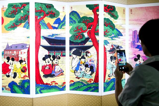 A visitor takes a photo at the MickeyFriends Seoul Tour exhibition at Deoksugung Palace in Jung-gu Seoul on Oct 4 2024 AJP Kim Dong-woo