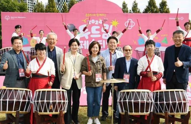 5일 서울 성수동 서울숲에서 열린 ‘홈플러스와 함께하는 2024 두드림 페스티벌’에서 발달장애인 타악기팀 ‘아리아난타’와 주요 인사들이 기념 촬영을 하고 있다 사진홈플러스