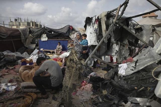 Displaced Palestinians inspect their tents destroyed by Israels bombardment adjunct to an UNRWA facility west of Rafah city in Gaza Strip on May 28 2024 AP-Yonhap