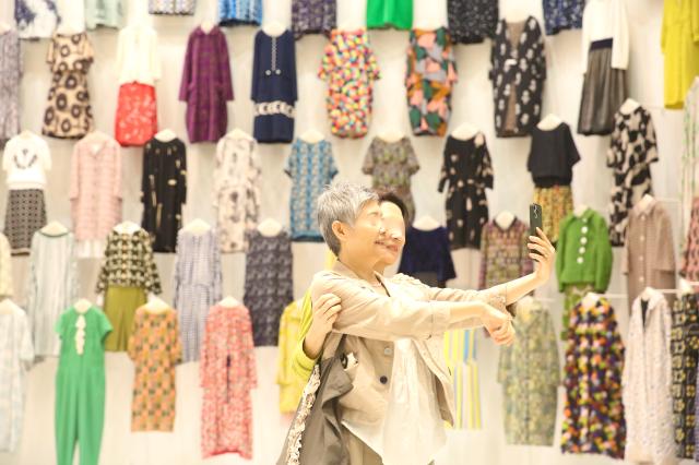 Visitors take commemorative photos at the mina perhonen exhibition held at DDP in Seoul on Sept 27 2024 AJP Han Jun-gu