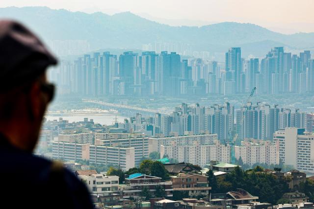 A pedestrian views Gangnam apartments from Namsan in Seoul South Korea on Sept 8 2024