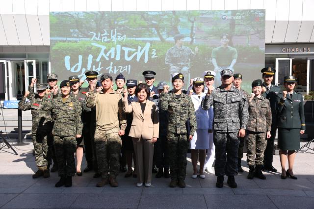 Minister Kang Jeong-ai third from left front row poses for a commemorative photo with models and veterans at the Military veterans week event at COEX in Seoul on Oct 8 2024 AJP Han Jun-gu