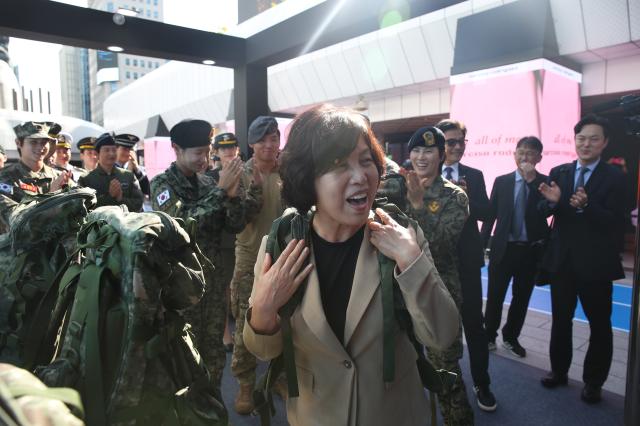 Minister of Patriots and Veterans Affairs Kang Jeong-ai tries on military gear at the experience zone during the Military veterans week event at COEX in Seoul on Oct 8 2024 AJP Han Jun-gu