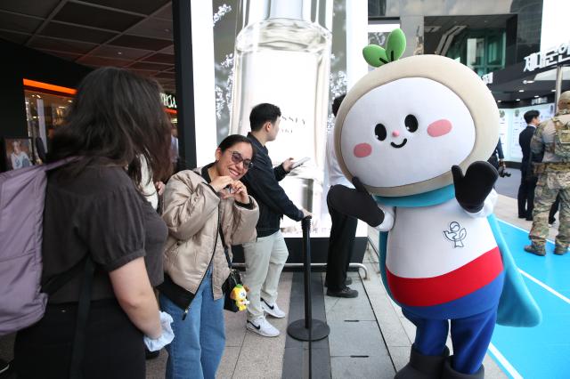 A visitor poses with the official mascot of the Ministry of Patriots and Veterans Affairs at the Military veterans week event at COEX in Seoul on Oct 8 2024 AJP Han Jun-gu