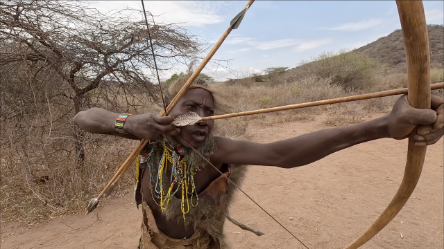 This photo shows a Hadza member shooting an arrow Courtesy of Typhoon Production