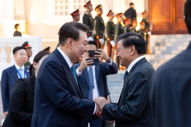 President Yoon Suk Yeol farewells Lao President Thongloun Sisoulith after talks in Vientiane on October 10 2024 Yonhap