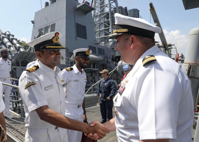 This photo shows Nicholas Maruca right commanding officer of USS Dewey greets Indian Navy Cmdr Swapnil Srivastava on Dewey’s quarterdeck after arriving in Visakhapatnam India for Exercise Malabar 2024 Courtesy of the US Navy