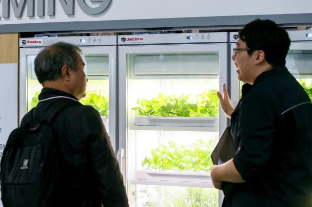 A visitor listens to a booth representative at the Seoul Smart Life Week held at COEX in Seoul on Oct 11 2024 AJP Kim Dong-woo