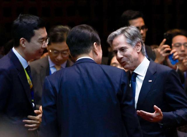 US Secretary of State Antony Blinken right speaks with South Korean President Yoon Suk Yeol center during a state dinner on the sidelines of the Association of Southeast Asian Nations ASEAN summit in Laos on Oct 10 2024 Yonhap