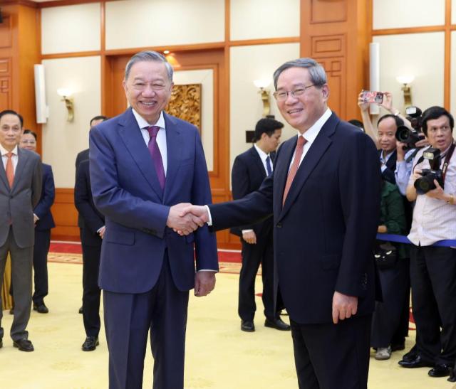 Chinese Premier Li Qiang shakes hands with To Lam General Secretary of the Communist Party of Vietnam Central Committee and President of Viet Nam in Hanoi Vietnam on Oct 12 2024 Xinhua-Yonhap