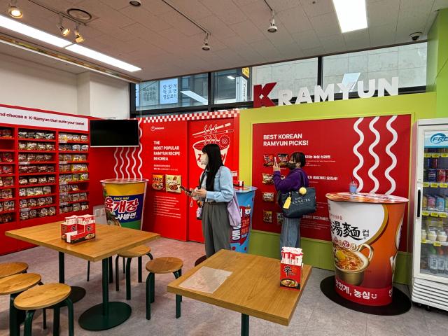 A visitor takes a photo at the K-Ramyun Supermarket in Myeongdong Seoul on Oct 14 2024 AJP Han Jun-gu