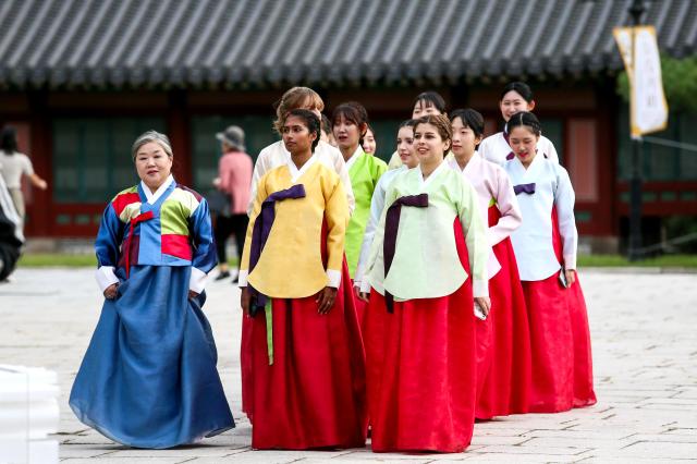 Foreign students attend a traditional coming-of-age ceremony at the National Folk Museum of Korea in Seoul on Oct 14 2024 AJP Kim Dong-woo