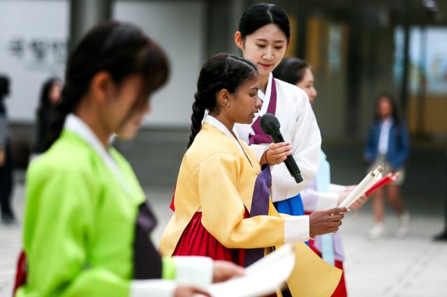 A student takes an oath during a traditional coming-of-age ceremony at the National Folk Museum of Korea in Seoul on Oct 14 2024 AJP Kim Dong-woo