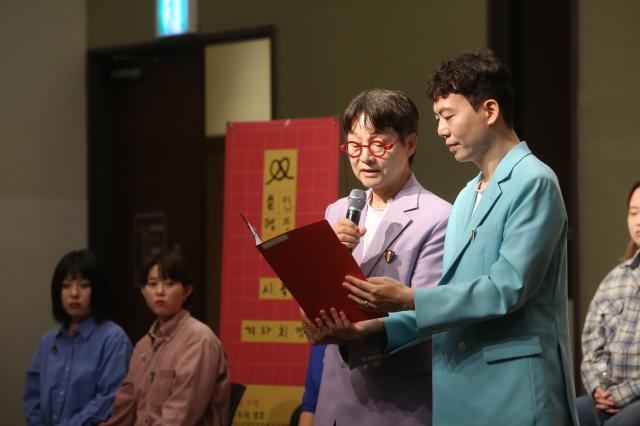 Same-sex couple Kim Jo-kwang-sooleft and Kim Seung-hwan give a speech at the press conference for a lawsuit seeking to legalize LGBT in Seoul on Oct 10 2024 AJP Han Jun-gu