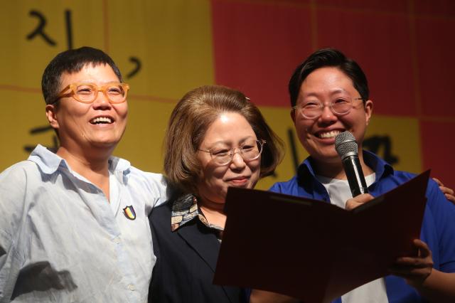 Same-sex couple Son Moon-sookleft and Park Ji-aright read a letter written by Park Ji-as mothercenter at the press conference for a lawsuit seeking to legalize LGBT in Seoul on Oct 10 2024 AJP Han Jun-gu