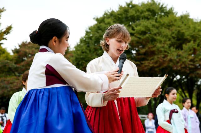 A student takes an oath during a traditional coming-of-age ceremony at the National Folk Museum of Korea in Seoul on Oct 14 2024 AJP Kim Dong-woo