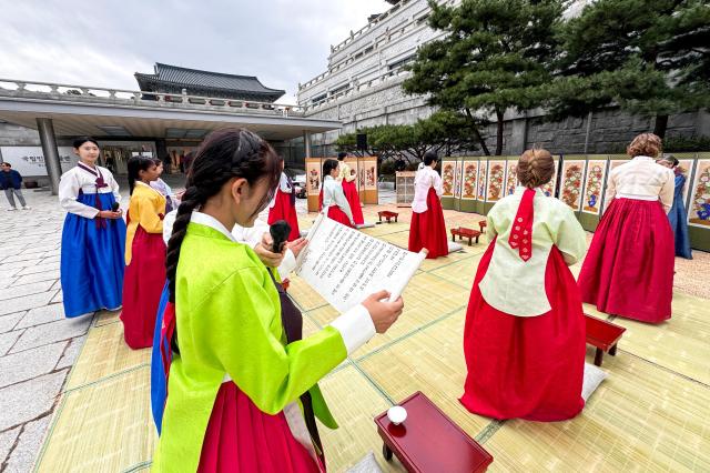 A student takes an oath during a traditional coming-of-age ceremony at the National Folk Museum of Korea in Seoul on Oct 14 2024 AJP Kim Dong-woo