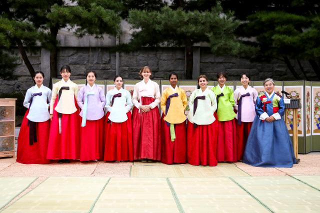 Foreign students pose for a photo after a traditional coming-of-age ceremony at the National Folk Museum of Korea in Seoul on Oct 15 2024 AJP Kim Dong-woo