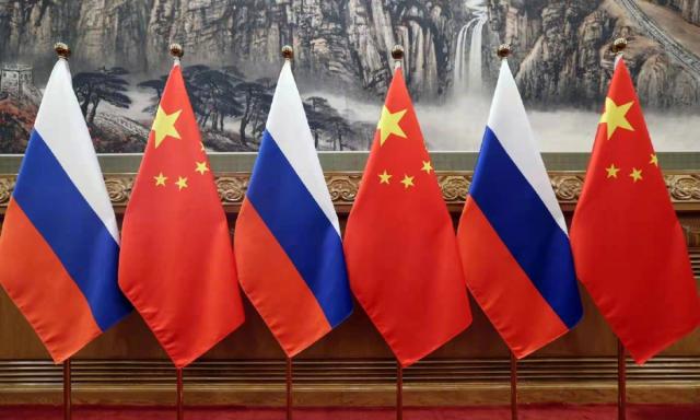 The image shows Russian and Chinese national flags Xinhua-Yonhap