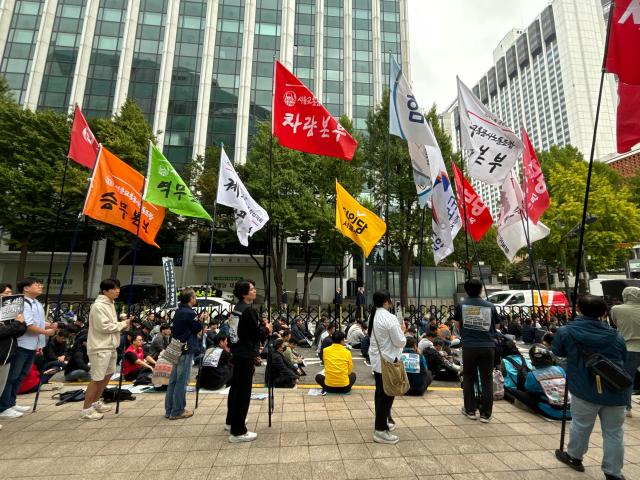 Seoul transit corporation labor union members hold flags during a rally and memorial service demanding an apology for a deceased worker near Seoul city hall Seoul on Oct 15 2024 AJP Han Jun-gu