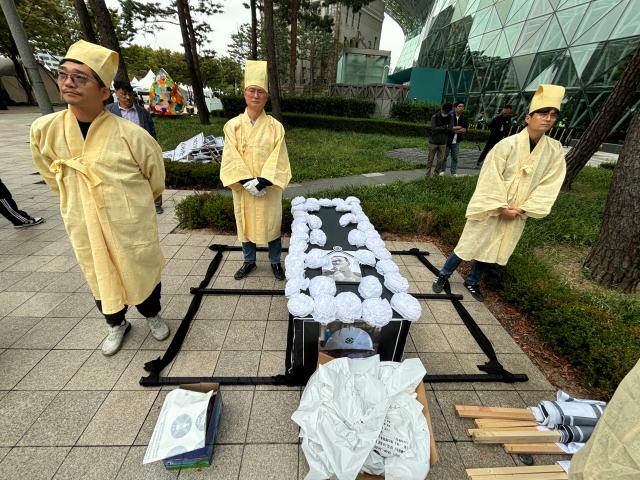 Seoul transit corporation labor union members prepare for a memorial service during a rally demanding an apology for a deceased worker near Seoul City Hall on Oct 15 2024 AJP Han Jun-gu