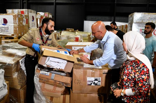 Lebanese Environment Minister Nasser Yassin along with volunteers organizes aid packages in warehouses in Beirut Lebanon on Oct 15 2024 EPA-Yonhap