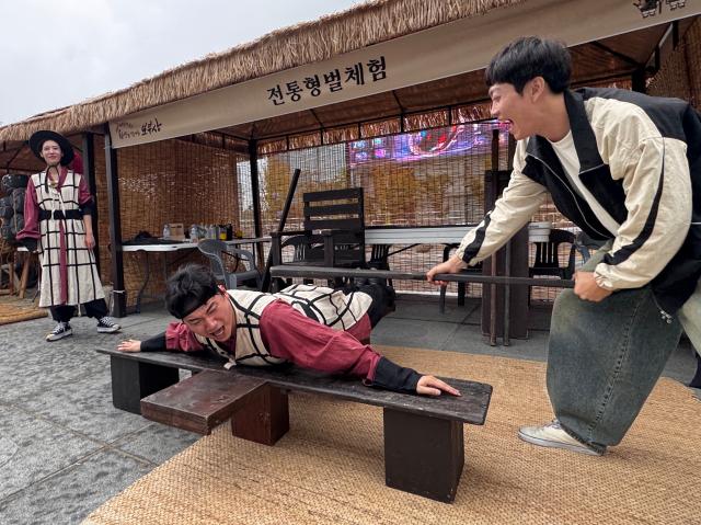 Visitors experience a traditional punishment at the Wow Festival in Gwanghwamun Plaza Seoul on Oct 15 2024 AJP Kim Dong-woo