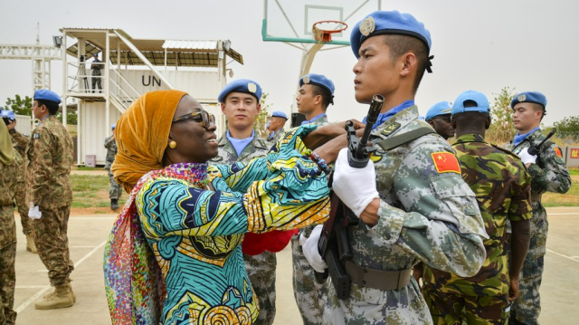 Anita Kiki Gebe the deputy joint special representative of the United Nations-African Union Mission in Darfur UNAMID presents a UN peace medal to a soldier from the 2nd China Medium Utility Helicopter Unit in El-Fashir Sudan on July 17 2019 Xinhua-Yonhap