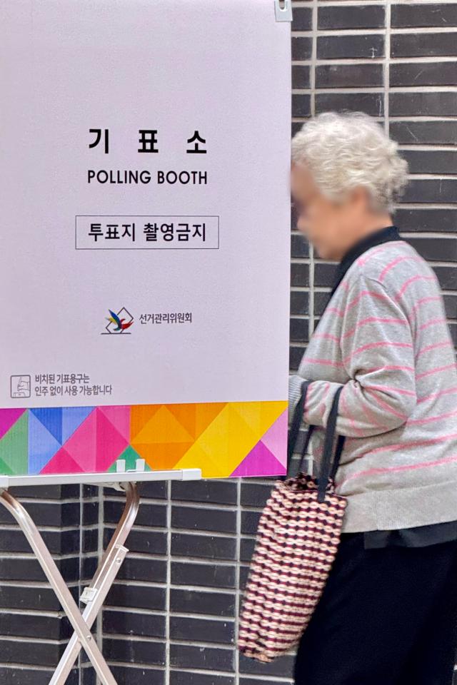 A voter enters a voting booth at a polling station in Seoul on Oct 16 2024 AJP Kim Dong-woo