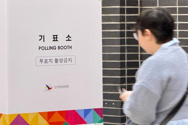 A voter enters a voting booth at a polling station in Seoul on Oct 16 2024 AJP Kim Dong-woo