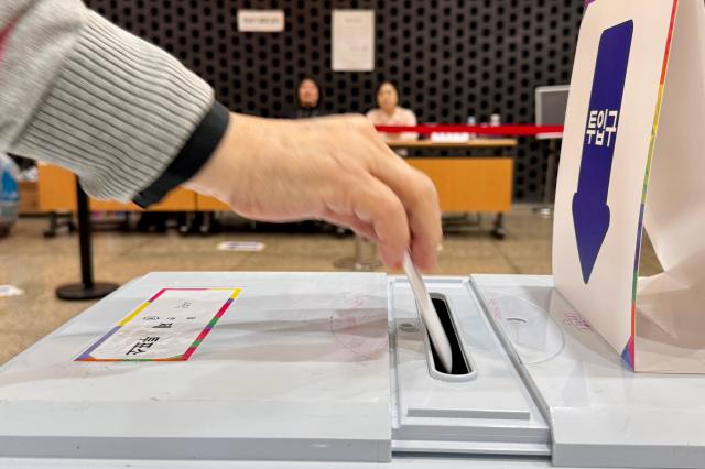 A voter casts a ballot at a polling station in Seoul on Oct 16 2024 AJP Kim Dong-woo