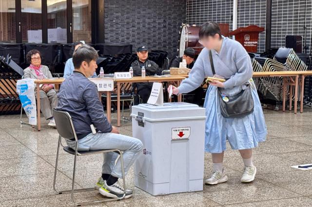 A voter casts a ballot at a polling station in Seoul on Oct 16 2024 AJP Kim Dong-woo