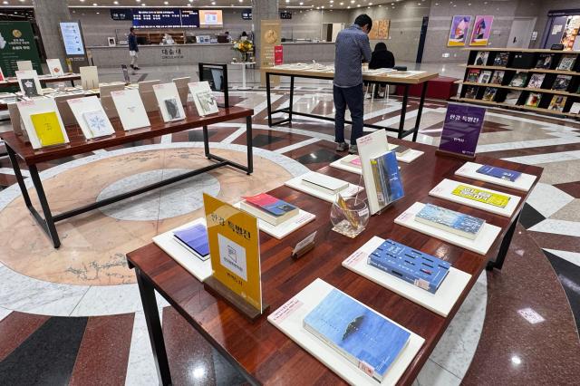 A visitor examines a book at the special exhibition for author Han Kang at the National Assembly Library in Seoul on Oct 16 2024 AJP Kim Dong-woo