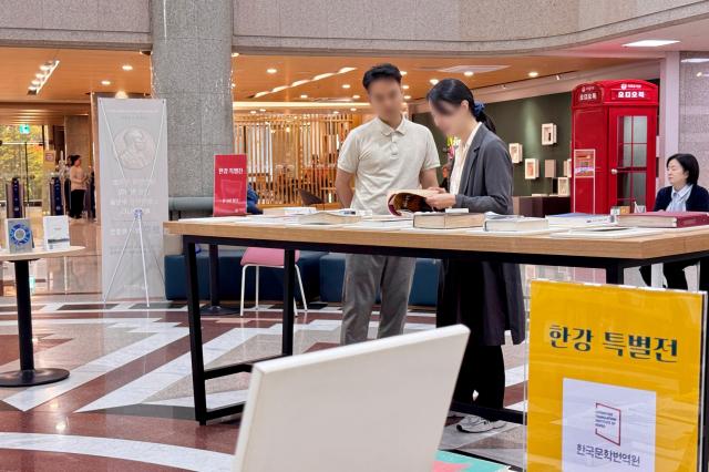 Visitors browse books at the special exhibition for author Han Kang at the National Assembly Library in Seoul on Oct 16 2024 AJP Kim Dong-woo