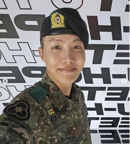 BTS member J-Hope is seen smiling in a South Korean military uniform Screenshot from J-Hopes Instagram