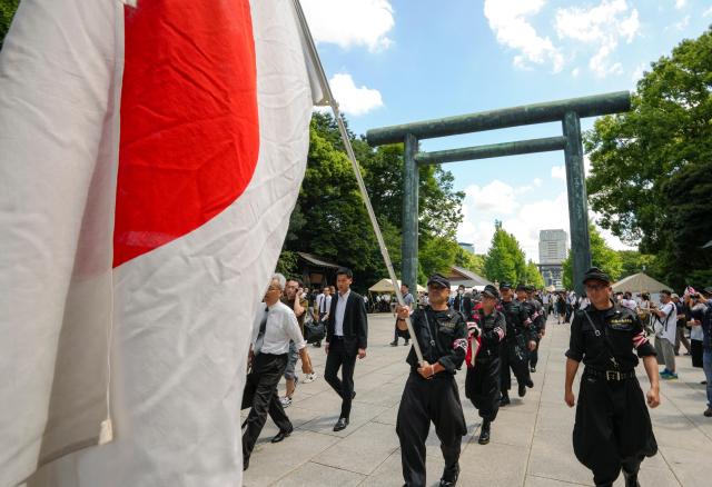 Nationalists holding a Japanese national flag as they visit Yasukuni Shrine to offer prayers for the war dead on the 79th anniversary of the end of World War Two in Tokyo Japan Aug 15 2024 EPA-Yonhap