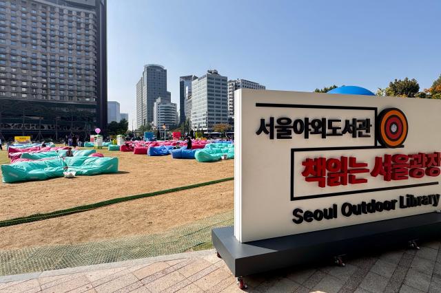 Visitors read books at the Seoul Outdoor Library in Seoul City Hall Plaza on Oct 17 2024 AJP Kim Dong-woo