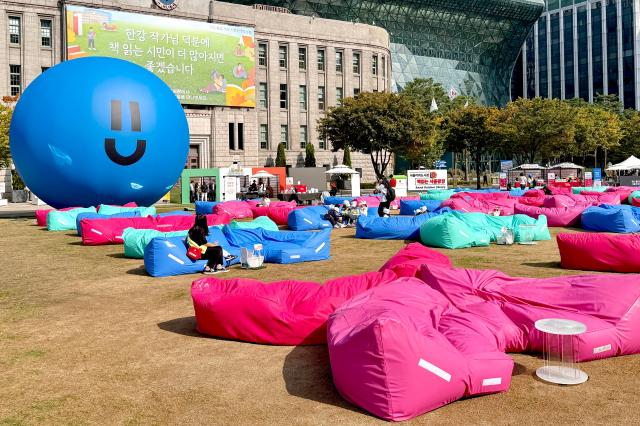 Visitors read books at the Seoul Outdoor Library in Seoul City Hall Plaza on Oct 17 2024 AJP Kim Dong-woo