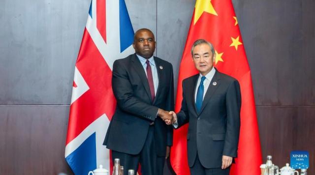 Chinese Foreign Minister Wang Yi shakes hadns with British Foreign Secretary David Lammy in Vientiane Laos on July 26 2024 Xinhua-Yonhap