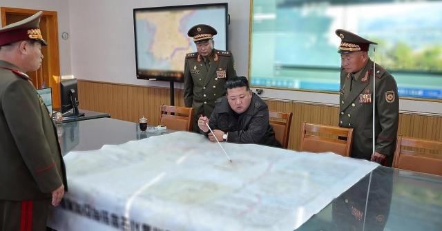 North Korean leader Kim Jong-un center gestures toward a location on a large map during his visit to the 2nd Corps of the Korean Peoples Army on Oct 17 2024 Yonhap