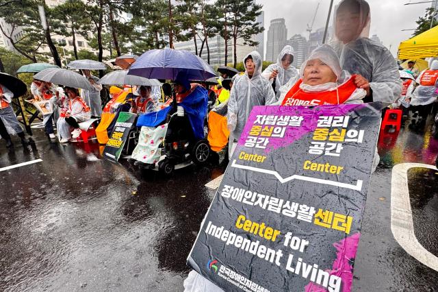 Members of the Korea Council of Centers for Independent Living rally in front of the National Assembly in Seoul on Oct 18 2024 calling for the enactment of the Independent Living Rights Guarantee Bill for people with disabilities by the end of the year AJP Kim Dong-woo