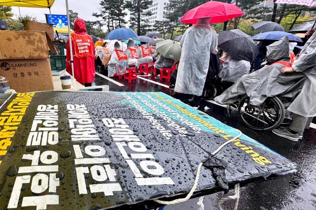 Picket signs are placed on a table during a disability rights rally in front of the National Assembly in Seoul on Oct 18 2024 AJP Kim Dong-woo