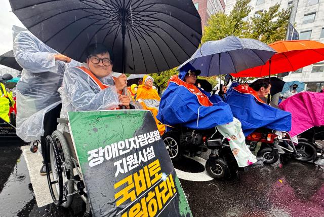 Members of the Korea Council of Centers for Independent Living rally in front of the National Assembly in Seoul on Oct 18 2024 calling for the enactment of the Independent Living Rights Guarantee Bill for people with disabilities by the end of the year AJP Kim Dong-woo