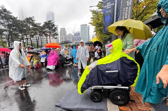 A participant moves to attend a rally for disability rights legislation in front of the National Assembly in Seoul on Oct 18 2024 AJP Kim Dong-woo