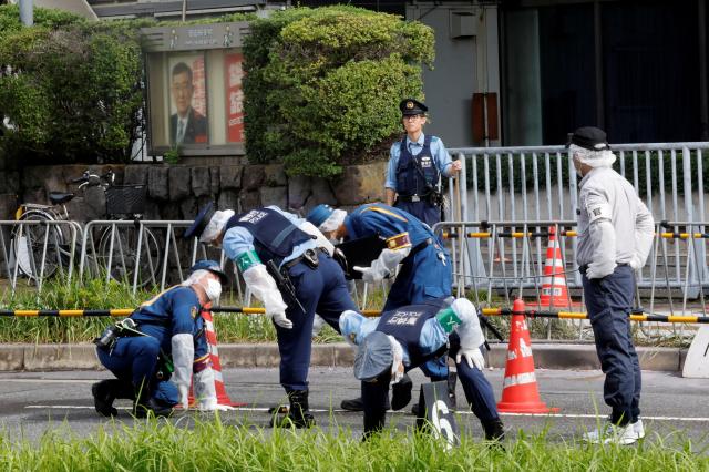 Police investigate outside the headquarters of the Liberal Democratic Party in Tokyo after a man reportedly threw Molotov cocktails at the building Oct 19 2024