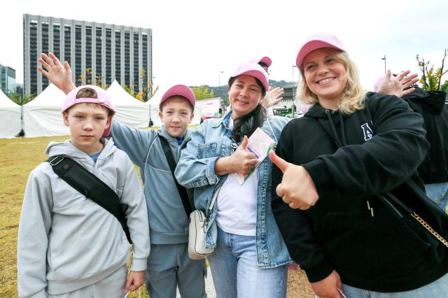 Participants pose for a photo before the start of the Walking Festival for Blue House and Five Royal Palaces in Seoul on Oct 19 2024 AJP Kim Dong-woo