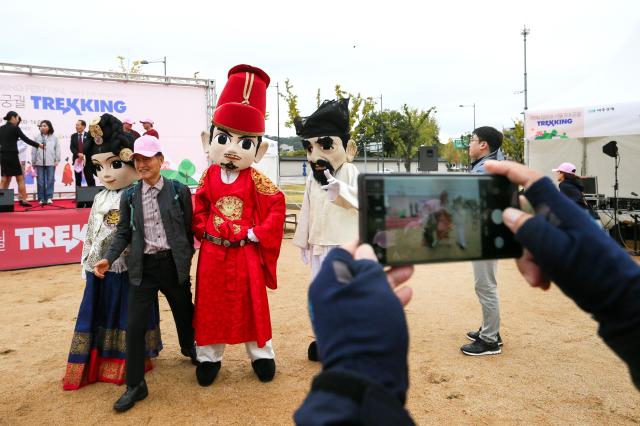 Participants pose for a photo before the start of the Walking Festival for Blue House and Five Royal Palaces in Seoul on Oct 19 2024 AJP Kim Dong-woo